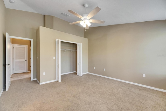 unfurnished bedroom featuring light carpet, a closet, and ceiling fan