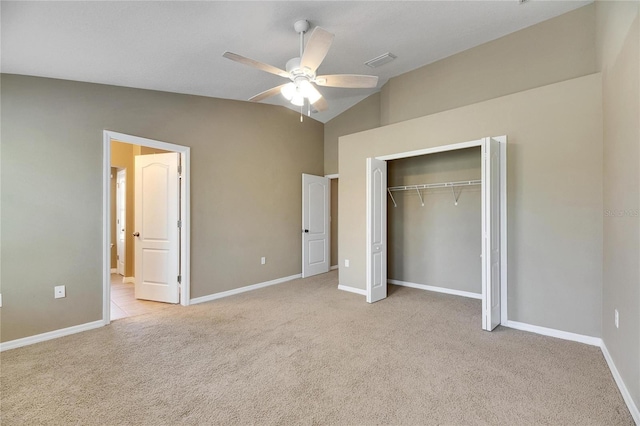 unfurnished bedroom with light carpet, a closet, ceiling fan, and lofted ceiling