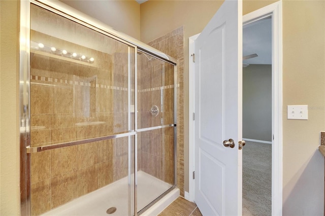 bathroom featuring tile patterned floors and a shower with door