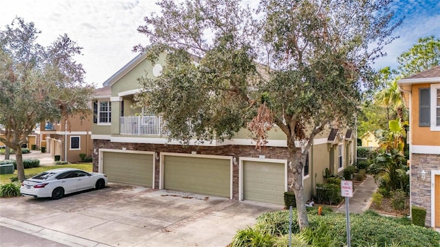 view of front of property featuring a balcony and a garage