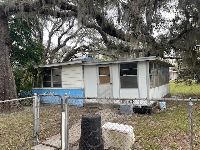 view of front of property with central AC unit and a front yard