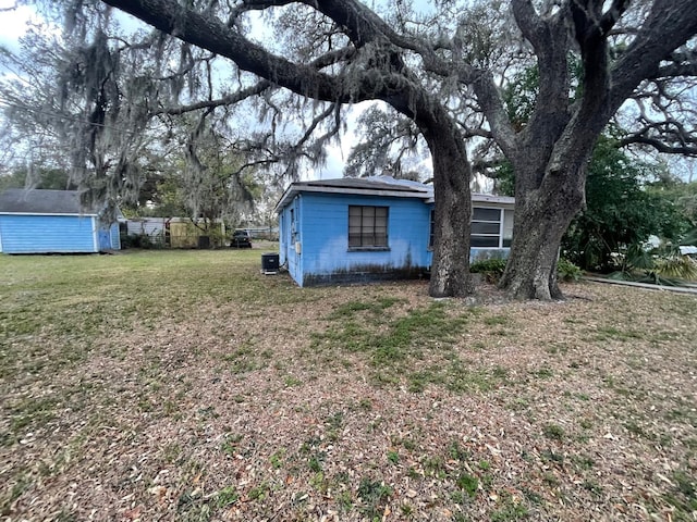 exterior space featuring a shed and a lawn