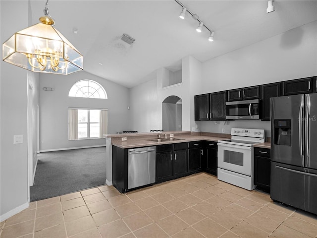 kitchen featuring sink, hanging light fixtures, light tile patterned floors, stainless steel appliances, and a chandelier