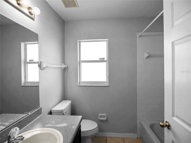 full bathroom featuring toilet, bathtub / shower combination, vanity, and tile patterned floors