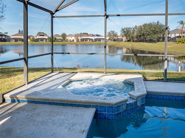 view of pool with a lanai, an in ground hot tub, and a water view