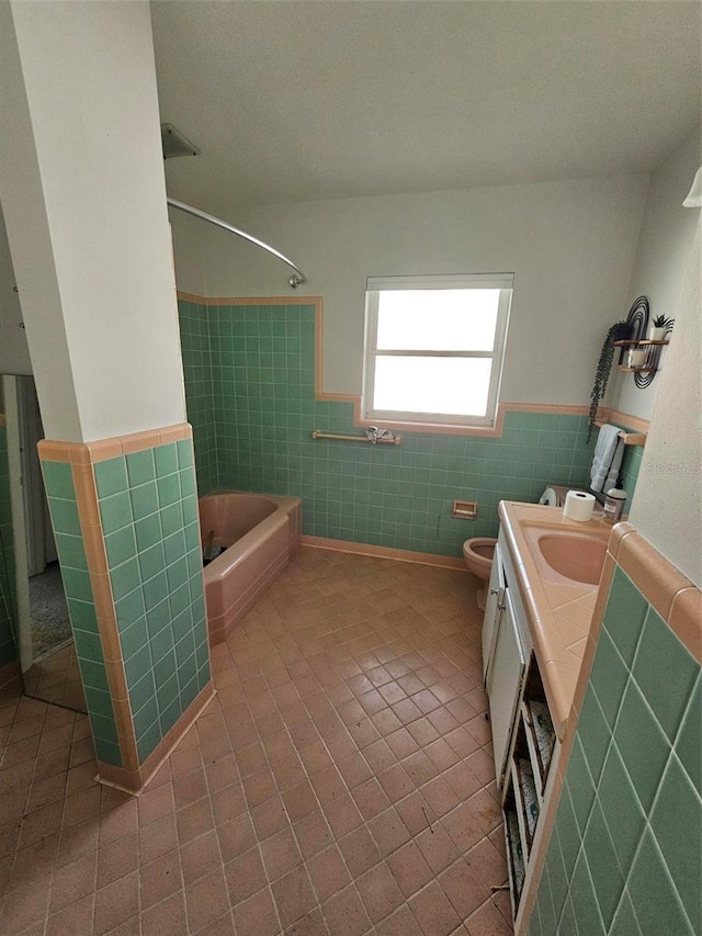 full bathroom featuring tile patterned floors, vanity, toilet, and tile walls