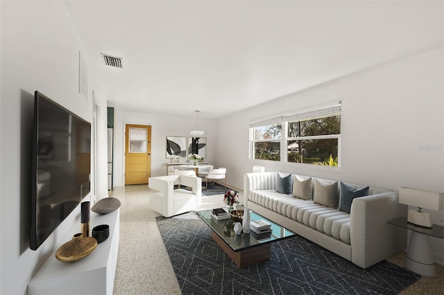 living room with visible vents and speckled floor