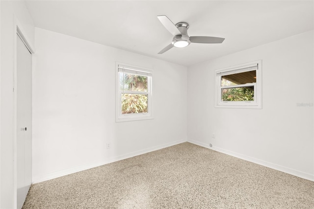 unfurnished room featuring baseboards and ceiling fan