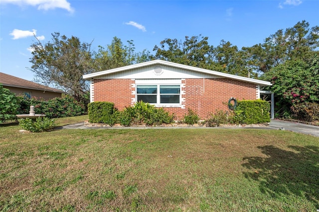 view of property exterior with brick siding and a lawn