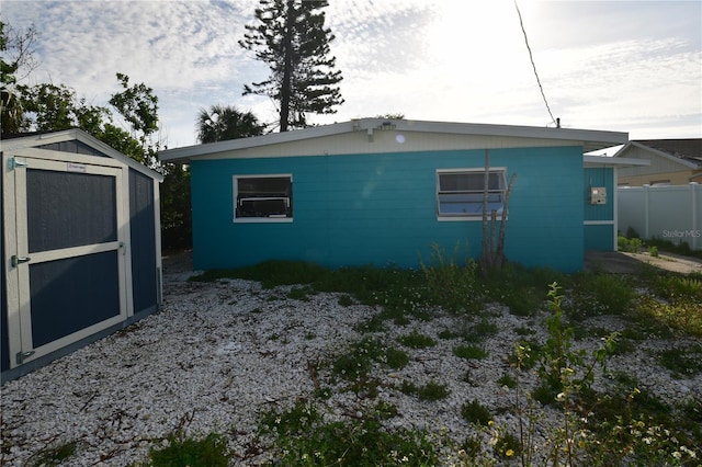 view of home's exterior with a storage shed