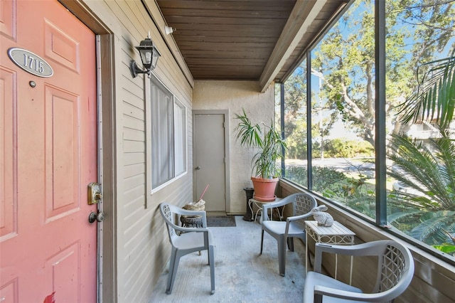 unfurnished sunroom with wood ceiling