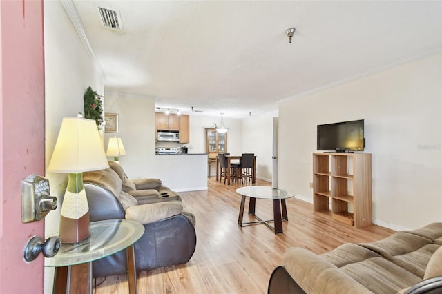 living room featuring light hardwood / wood-style floors and ornamental molding