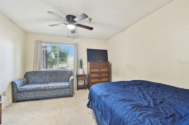 bedroom featuring carpet flooring, a textured ceiling, and ceiling fan