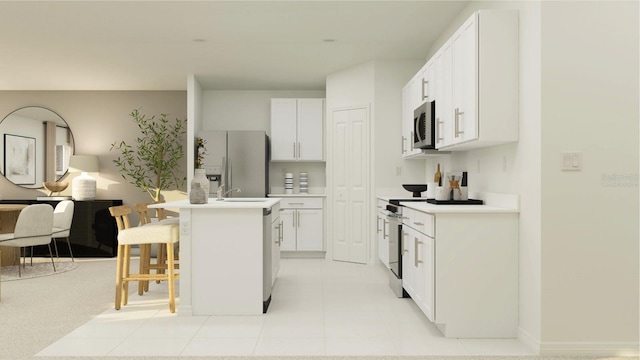 kitchen featuring a center island with sink, white cabinets, a kitchen bar, and appliances with stainless steel finishes