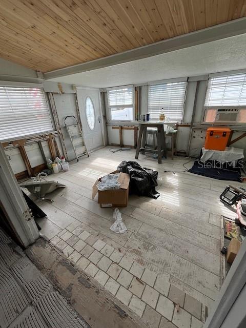 misc room featuring cooling unit, wood ceiling, and lofted ceiling