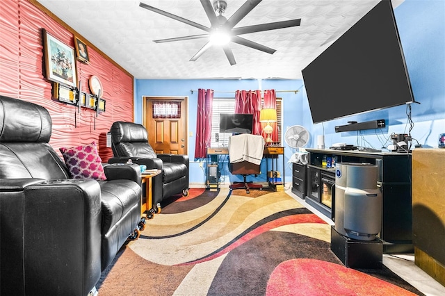 living room featuring ceiling fan, carpet floors, and a textured ceiling