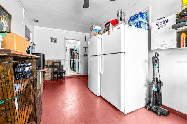 kitchen with ceiling fan, a textured ceiling, and white refrigerator