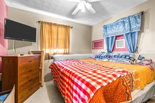 bedroom with ceiling fan and light tile patterned flooring