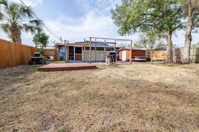 back of house featuring a pergola, a storage shed, and a deck