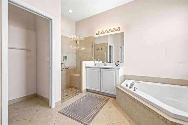 bathroom featuring tile patterned floors, vanity, and independent shower and bath