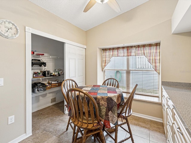 tiled dining area with ceiling fan