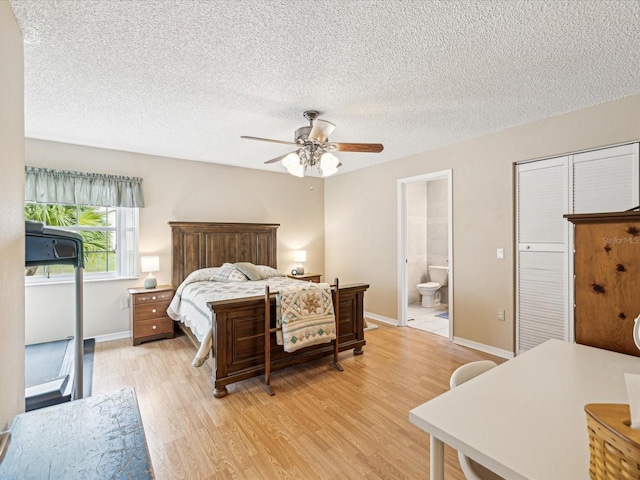 bedroom with a textured ceiling, ensuite bathroom, light hardwood / wood-style flooring, and ceiling fan