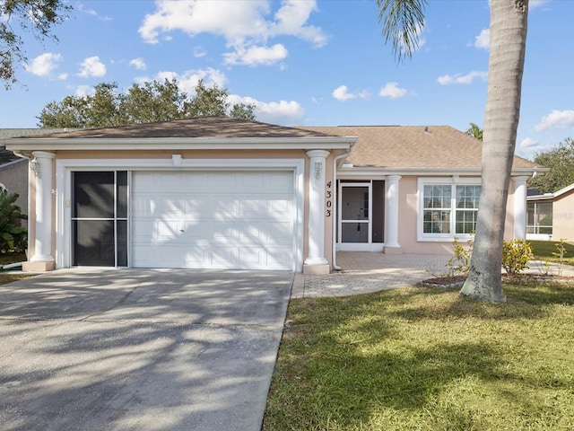 ranch-style home with a garage and a front lawn