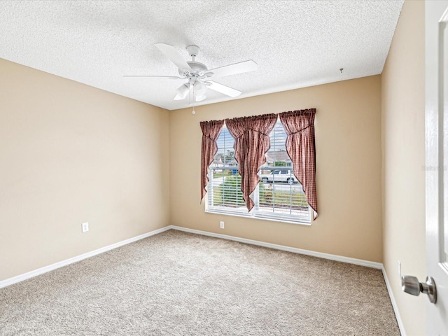 unfurnished room featuring carpet, ceiling fan, and a textured ceiling