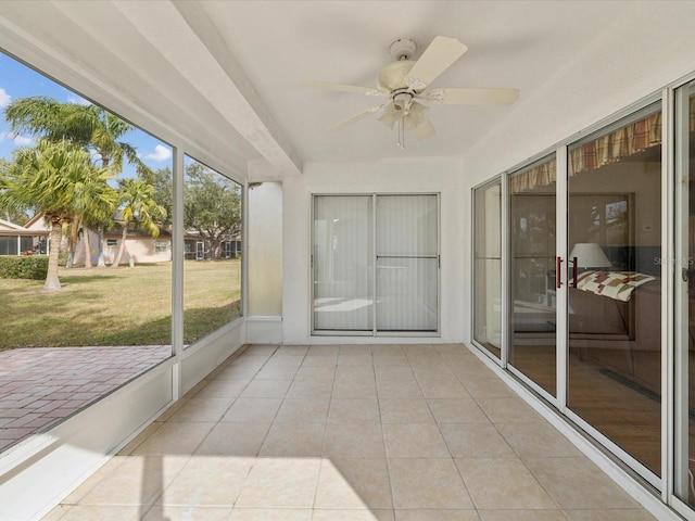 unfurnished sunroom featuring ceiling fan and plenty of natural light