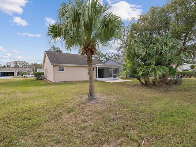 back of property with a lawn, cooling unit, and a patio