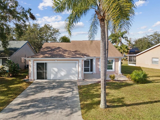 view of front of house with a garage and a front lawn