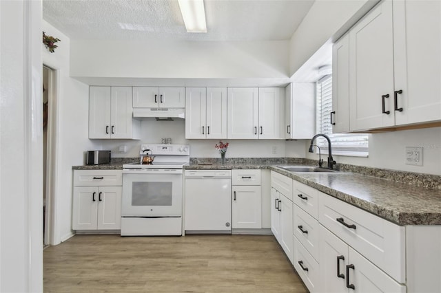 kitchen featuring light wood-type flooring, a textured ceiling, white appliances, sink, and white cabinetry