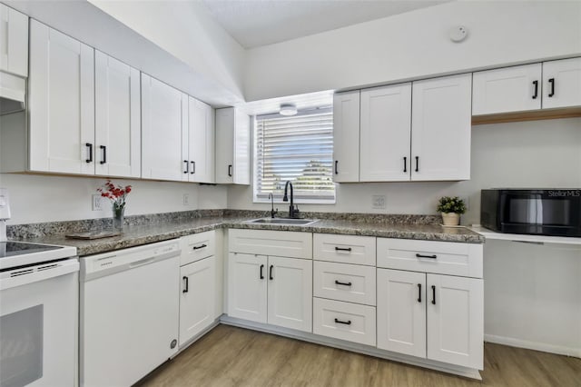 kitchen featuring sink, white cabinets, light hardwood / wood-style floors, and white appliances