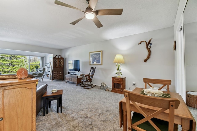 carpeted living room with a textured ceiling and ceiling fan