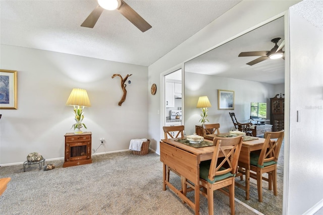 dining room featuring carpet flooring, ceiling fan, and a textured ceiling