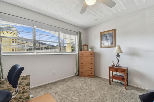 office area featuring ceiling fan, light colored carpet, and a textured ceiling