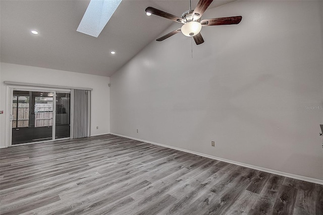 unfurnished room featuring a skylight, ceiling fan, french doors, high vaulted ceiling, and wood-type flooring