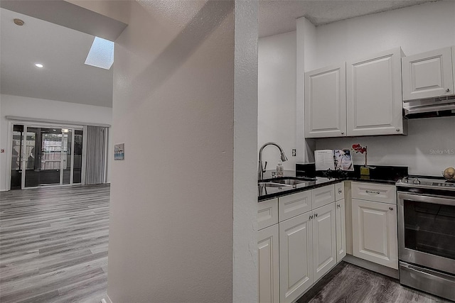 kitchen with white cabinets, dark hardwood / wood-style flooring, sink, and electric stove