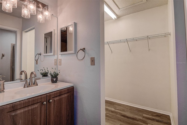 bathroom with vanity, wood-type flooring, and a textured ceiling