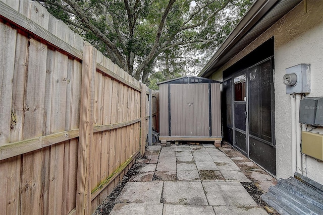 view of patio / terrace featuring a storage shed