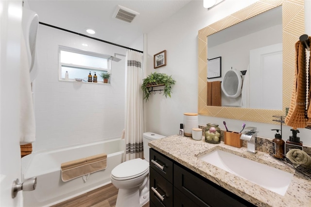 full bathroom with toilet, hardwood / wood-style flooring, vanity, and shower / bath combo with shower curtain