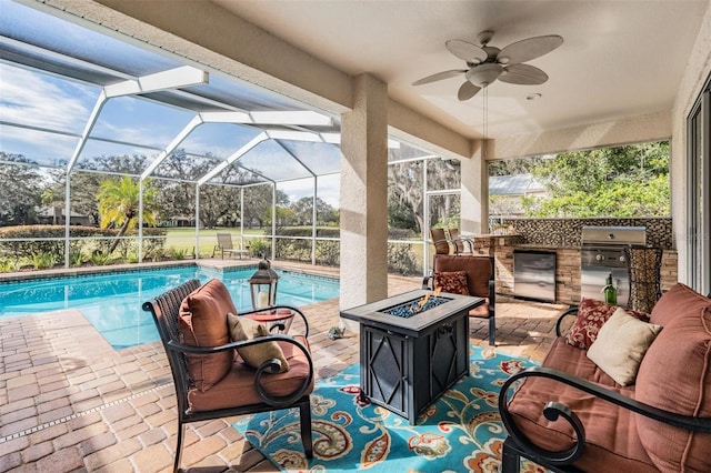 view of swimming pool with ceiling fan, area for grilling, a patio, and a grill