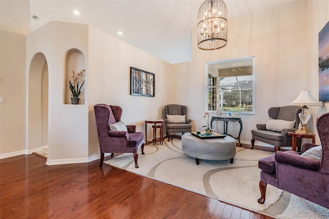 sitting room featuring a chandelier and hardwood / wood-style flooring