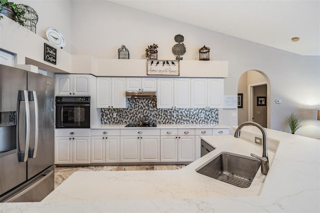 kitchen featuring black appliances, white cabinets, and backsplash