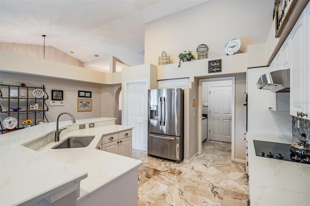 kitchen featuring sink, stainless steel fridge with ice dispenser, light stone counters, black electric cooktop, and exhaust hood