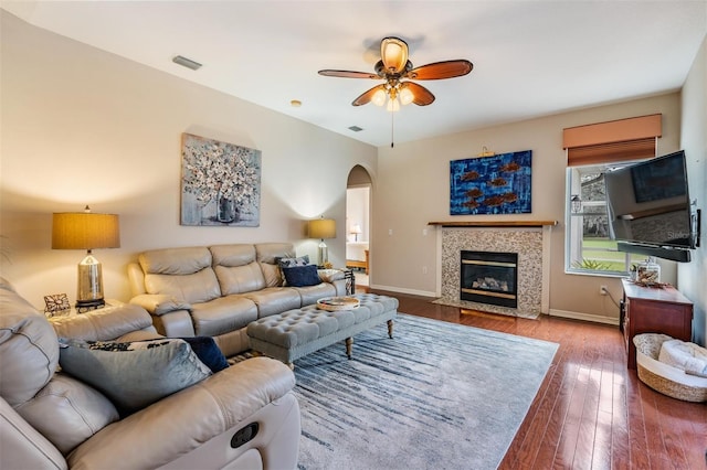 living room featuring ceiling fan and wood-type flooring