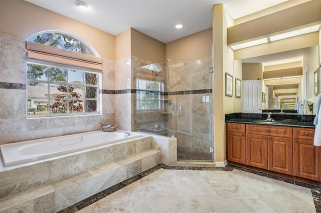 bathroom featuring plus walk in shower and vanity