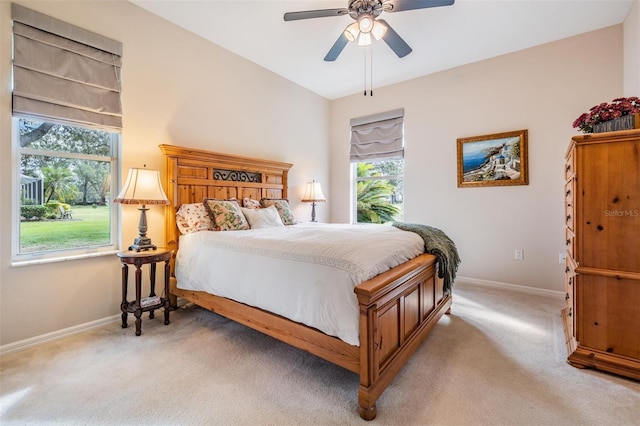 bedroom featuring light colored carpet and ceiling fan