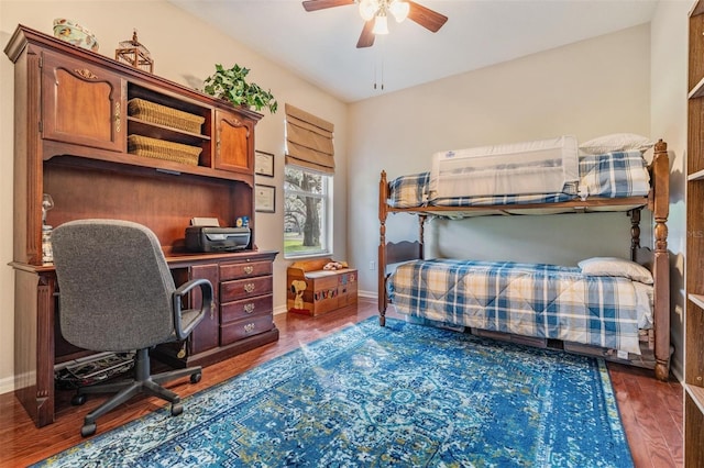 bedroom with ceiling fan and dark wood-type flooring