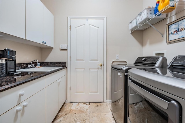 laundry room with cabinets, independent washer and dryer, and sink